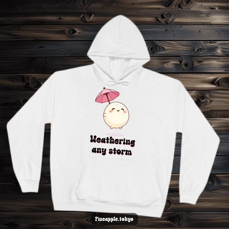 Funny adorable mochi ball bouncing with a tiny umbrella, featured on a warm and humorous hoodie. Cozy dessert apparel.