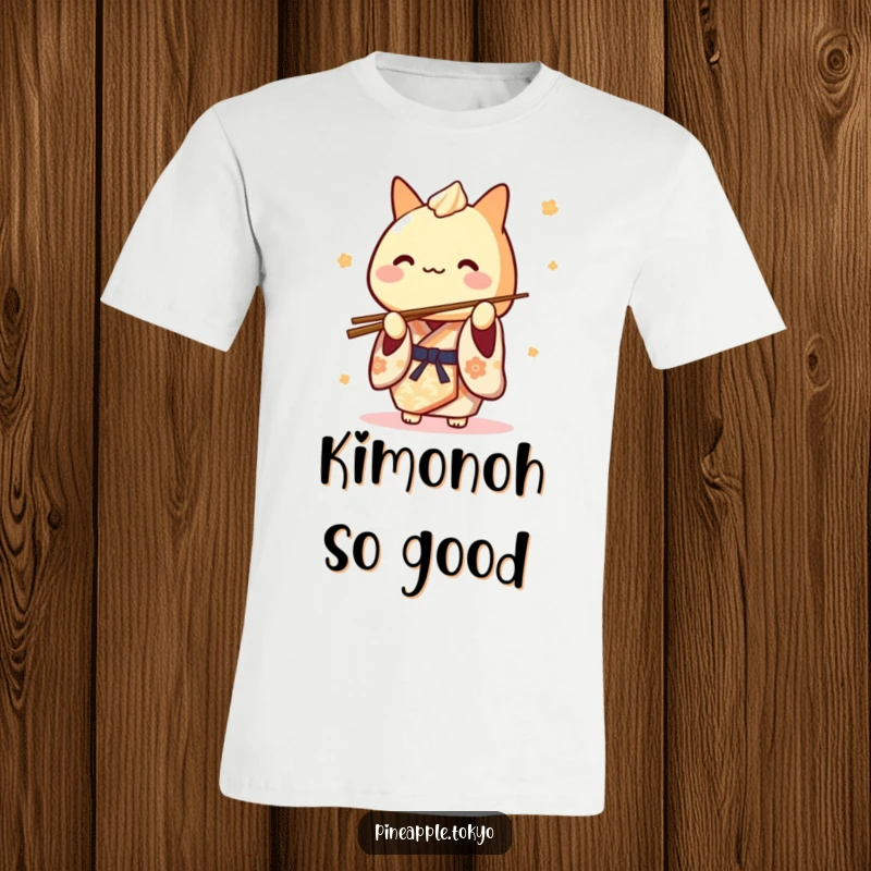 Funny Tamagoyaki Kimono T-Shirt: a cute Japanese rolled omelet character in a kimono playfully balancing chopsticks, wearing a chef's hat.